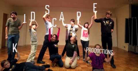 a group of people standing on top of a wooden floor
