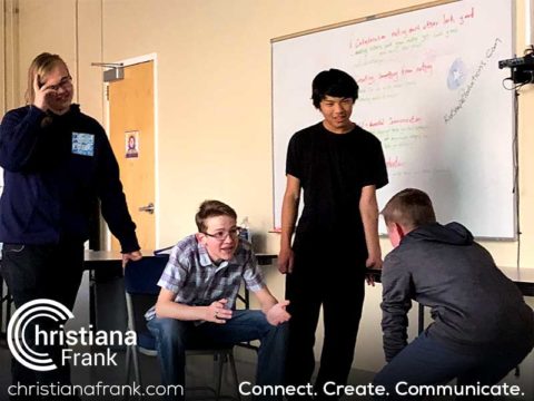 a group of young men standing next to each other in front of a whiteboard