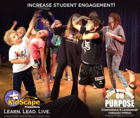 a group of children are dancing on stage