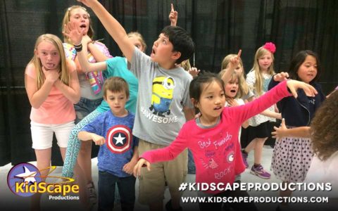 a group of children standing around each other