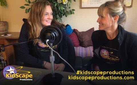 two women sitting on a couch talking to each other